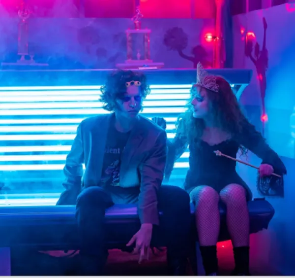 Young man and woman sitting by a window