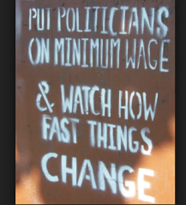 Sign that says Put Politicians on minimum wage and watch how fast things change
