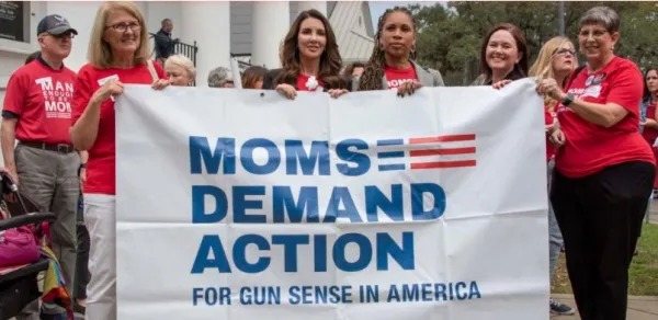 Women holding Moms Demand Action banner