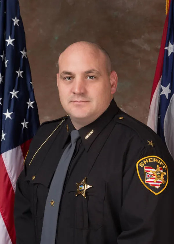 Bald white man in a sheriff uniform