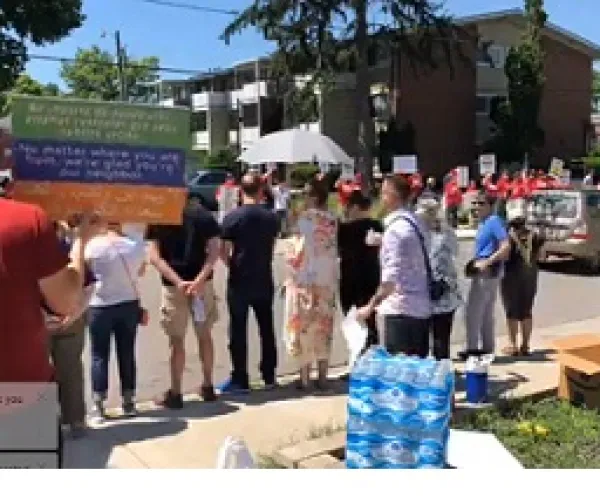 People on both sides of a street protesting each other
