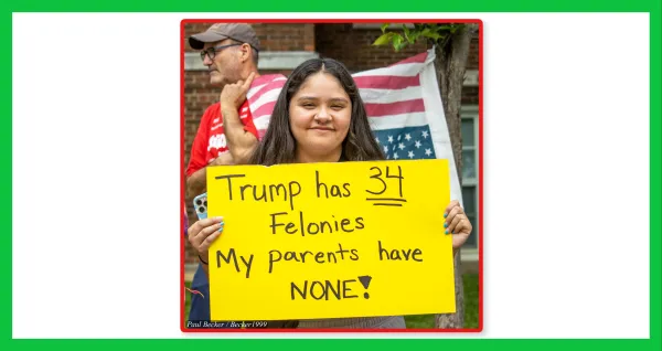 Woman with sign saying Trump has 34 felonies, my parents have NONE