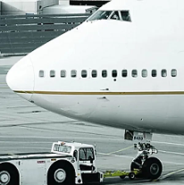 Nose of a jet with a truck next to it