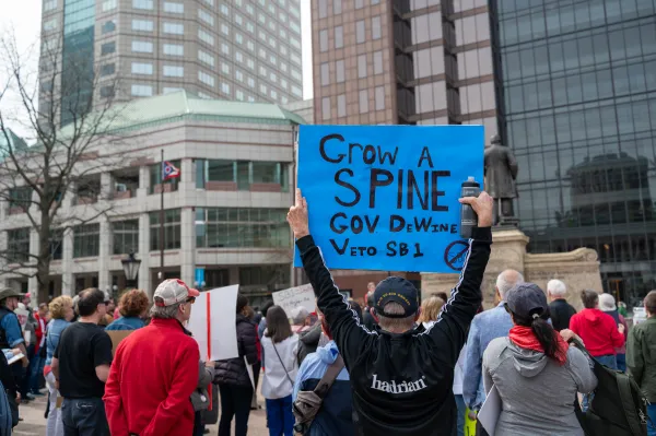 Sign says Grow A Spine Gov Dewine At Protest