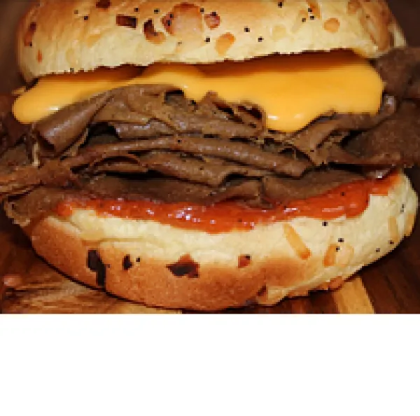 Big bun burger-looking sandwich close-up except it's like layers of beef (though not meat) with cheddar cheese (though not cheese)