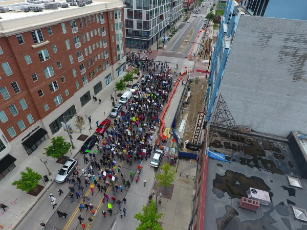 Downtown street with thousands of people marching