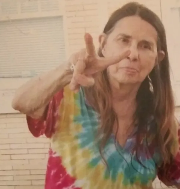 Margaret Sarber making a peace sign