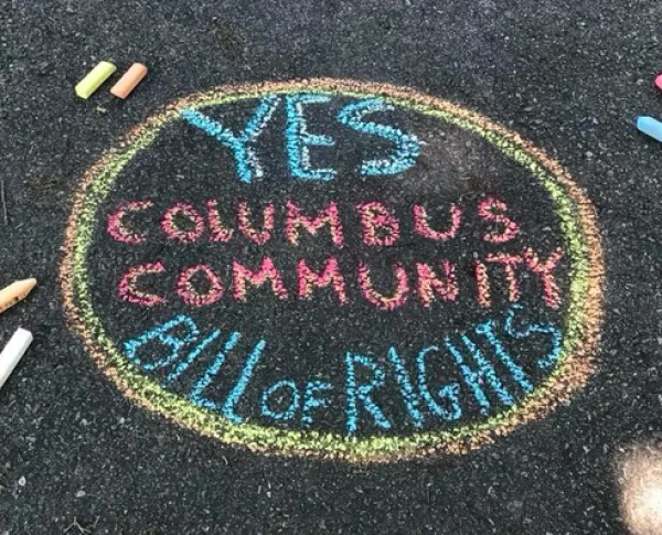Chalk words on ground Yes Columbus Community Bill of Rights