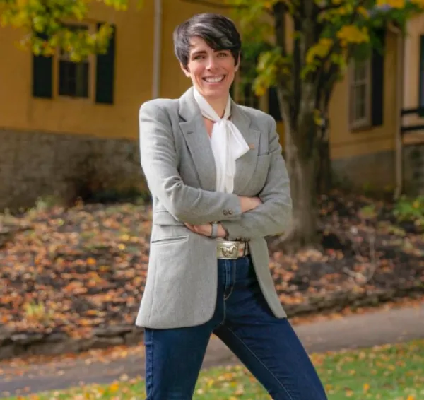 Young woman smiling and standing outside