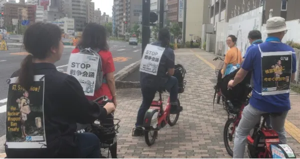 People riding bikes with signs