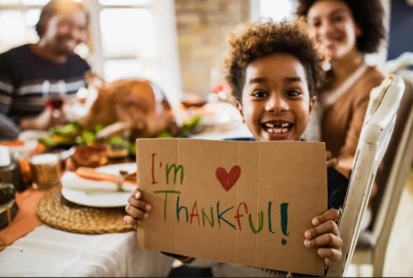 Little boy holding sign I'm Thankful