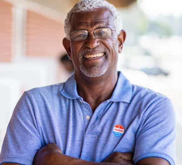 Man with voting sticker on shirt