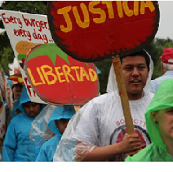 People outside marching holding signs Justica and Libertad