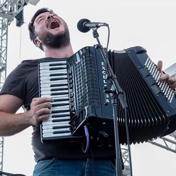 Guy singing with accordion